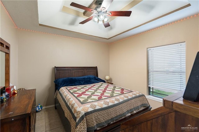 bedroom featuring a tray ceiling, ceiling fan, and tile patterned flooring