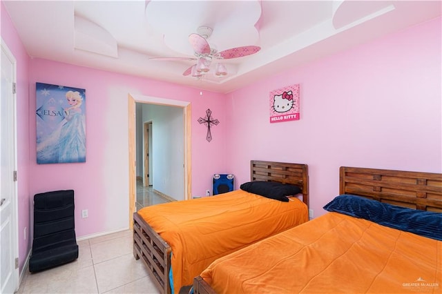 tiled bedroom featuring ceiling fan