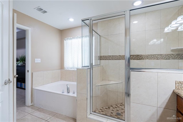 bathroom featuring tile patterned flooring, vanity, and shower with separate bathtub