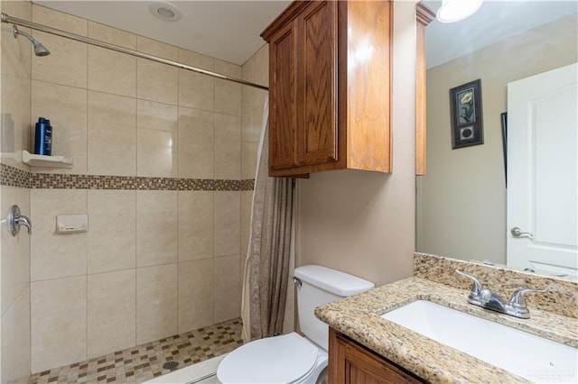 bathroom with a shower with shower curtain, vanity, and toilet