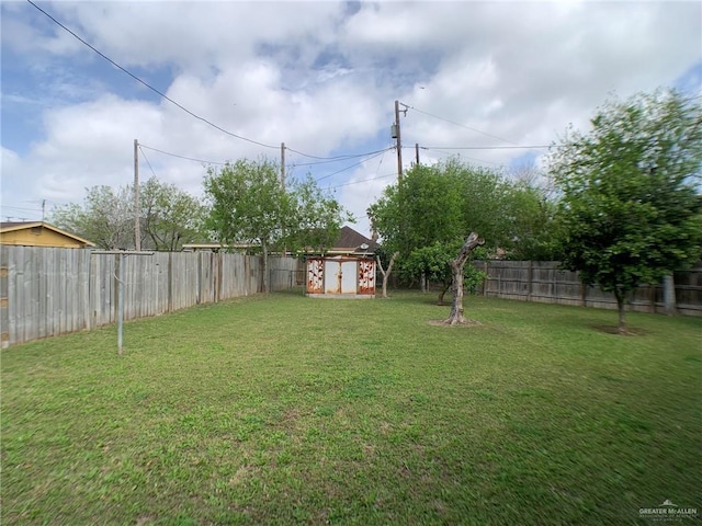 view of yard featuring an outbuilding, a shed, and a fenced backyard