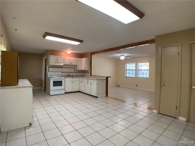 kitchen featuring tasteful backsplash, light countertops, light tile patterned floors, white range with electric stovetop, and a sink