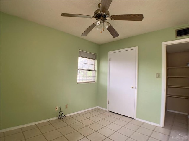 unfurnished bedroom with a ceiling fan, baseboards, visible vents, and a closet