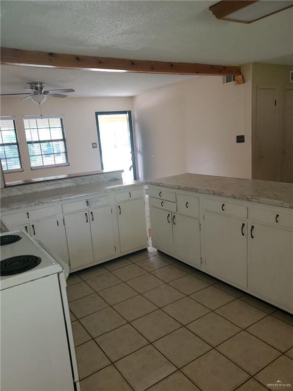 145 Draper Dr, Brownsville, TX 78521 - kitchen featuring range with electric cooktop, light tile patterned floors, white cabinets, ceiling fan, and light countertops