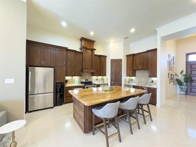 kitchen featuring tasteful backsplash, a breakfast bar, a kitchen island, and stainless steel appliances