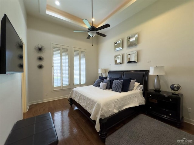 bedroom with ceiling fan and dark wood-type flooring