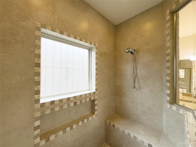 bathroom with a tile shower