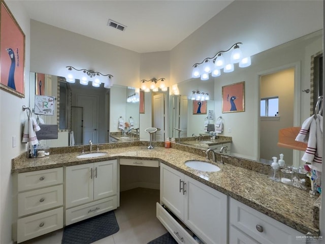 bathroom featuring tile patterned flooring and vanity