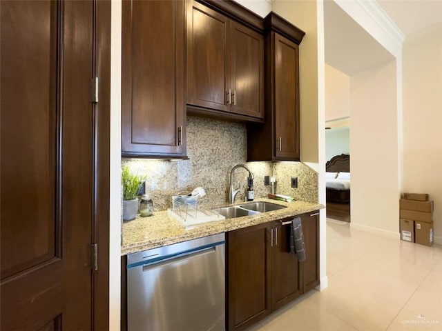 kitchen with light stone countertops, sink, stainless steel dishwasher, decorative backsplash, and ornamental molding