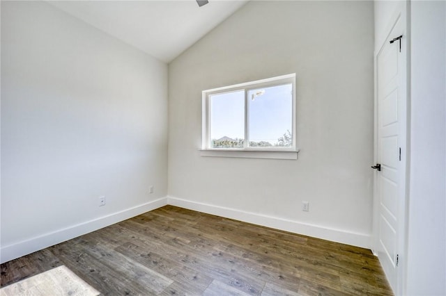 empty room featuring dark hardwood / wood-style flooring and lofted ceiling