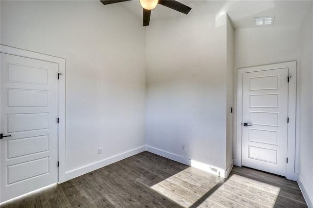 entryway with lofted ceiling, ceiling fan, and dark hardwood / wood-style flooring