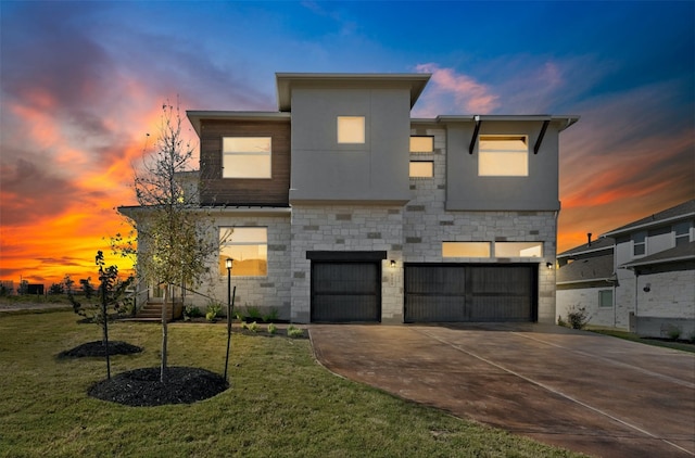 contemporary house with a yard and a garage