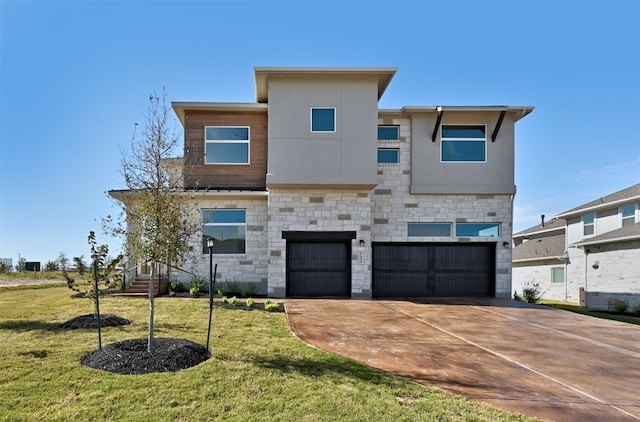 view of front of house with a front yard and a garage