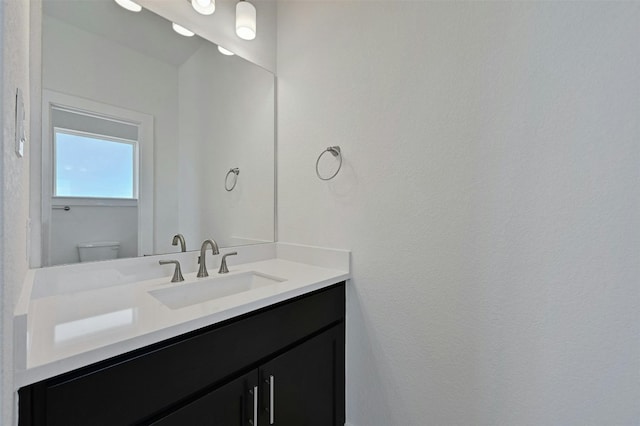 bathroom with toilet and vanity