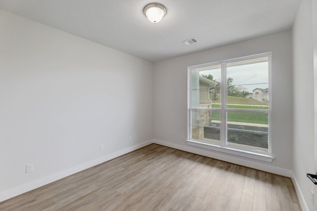 unfurnished room with light hardwood / wood-style floors