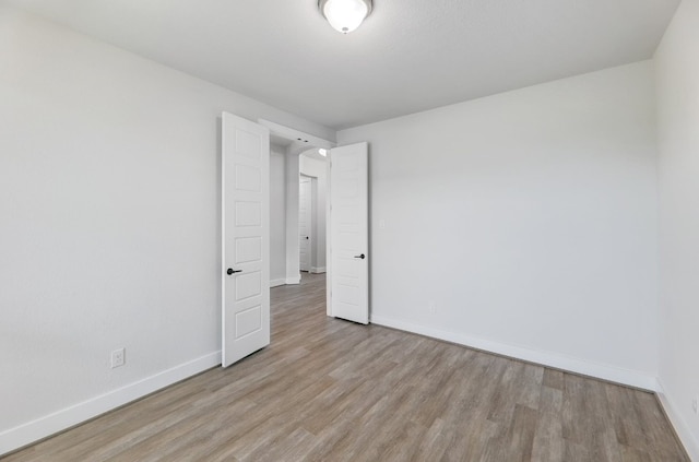 unfurnished room featuring light hardwood / wood-style floors