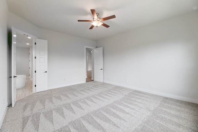 carpeted spare room with ceiling fan