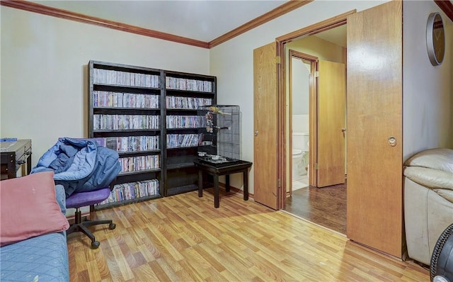 home office featuring crown molding and light hardwood / wood-style floors