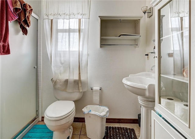 bathroom with toilet and tile flooring