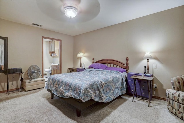 carpeted bedroom featuring ceiling fan and ensuite bathroom