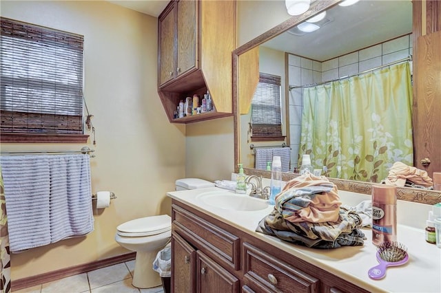 bathroom with toilet, tile floors, and large vanity