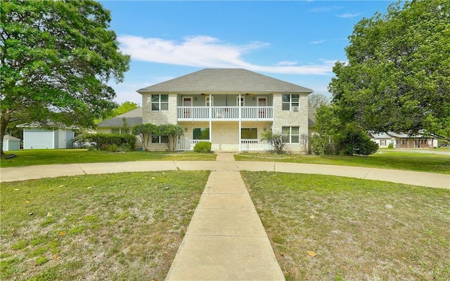 view of front of home featuring a front lawn, a porch, and a garage