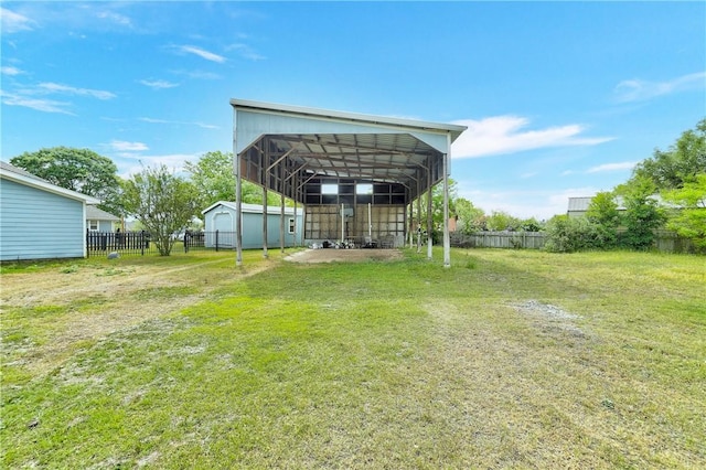 view of yard with a storage unit and a carport