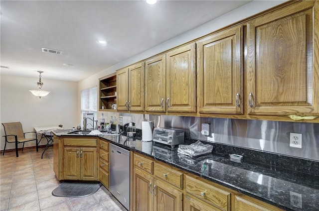 kitchen with dark stone counters, pendant lighting, light tile floors, and dishwasher