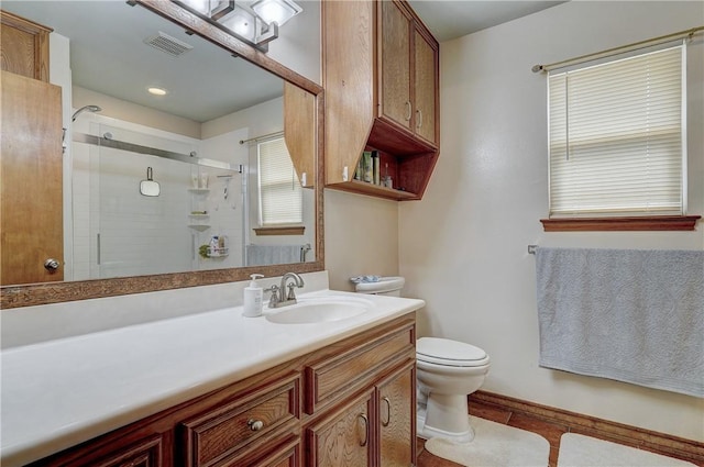 bathroom featuring walk in shower, tile floors, toilet, and vanity