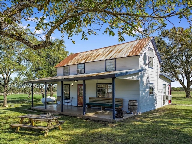 back of house featuring a porch and a yard