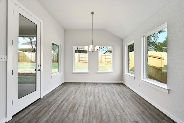 unfurnished sunroom with plenty of natural light, a notable chandelier, and lofted ceiling