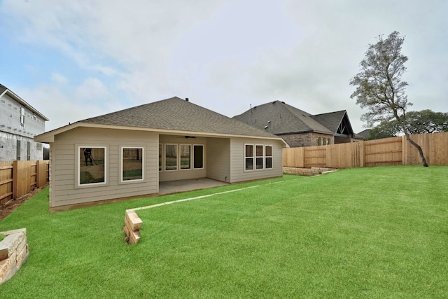 back of property with a patio area and a lawn