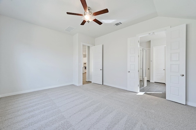 unfurnished bedroom with ceiling fan, lofted ceiling, and light carpet