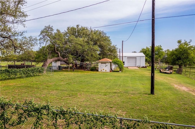 view of yard with an outdoor structure and a garage