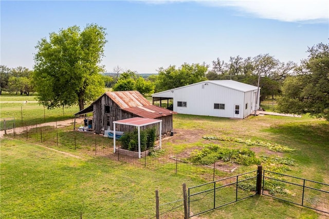 view of yard with an outdoor structure and a rural view