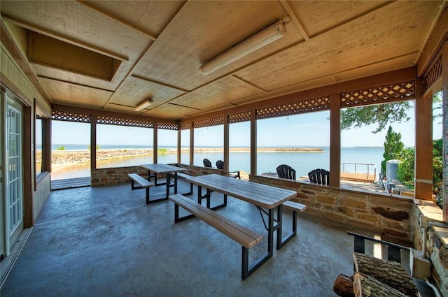 sunroom / solarium with a water view