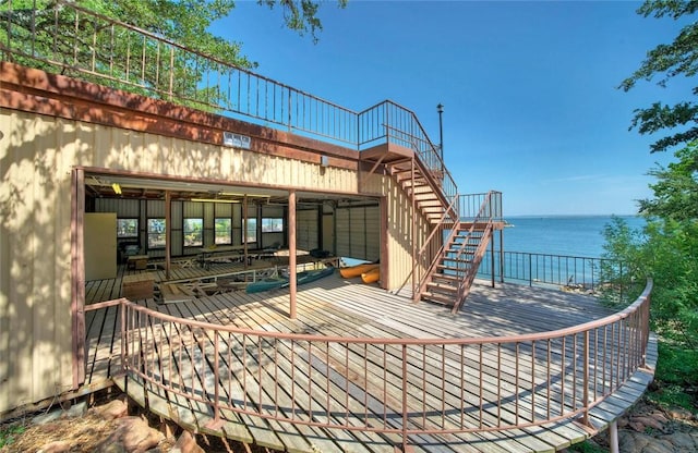 view of terrace with a deck with water view