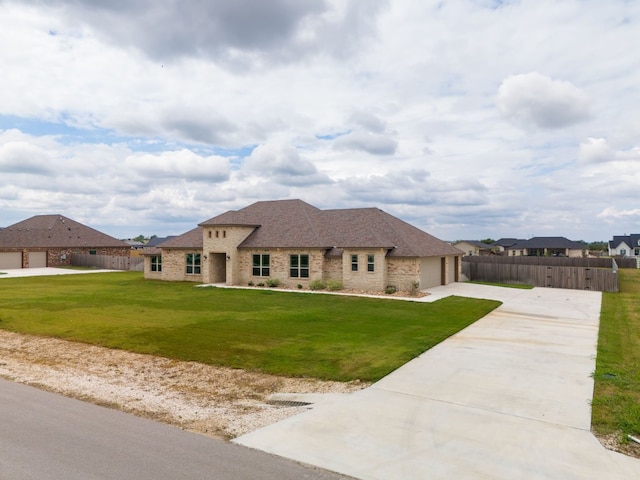 view of front facade featuring a front yard and a garage