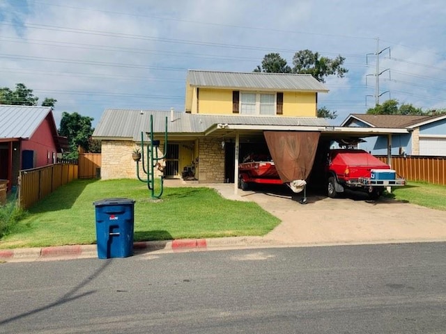 view of front facade with a carport and a front yard