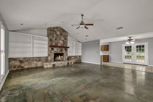 unfurnished living room with french doors, concrete floors, ceiling fan, and a fireplace