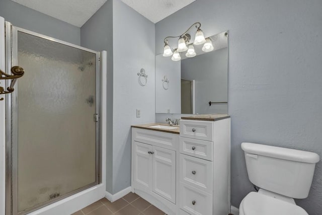 bathroom with toilet, a textured ceiling, vanity, walk in shower, and tile floors