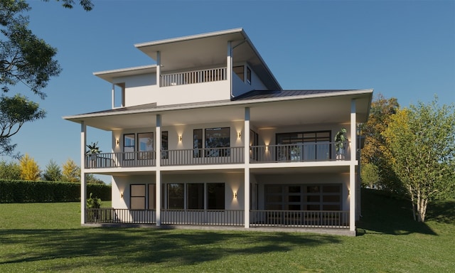 back of property with a balcony and a yard