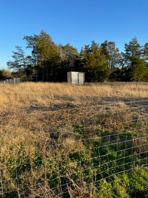 view of yard with a rural view