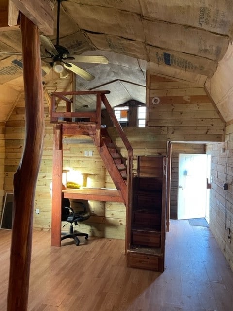 bonus room featuring wooden walls, vaulted ceiling, and hardwood / wood-style flooring