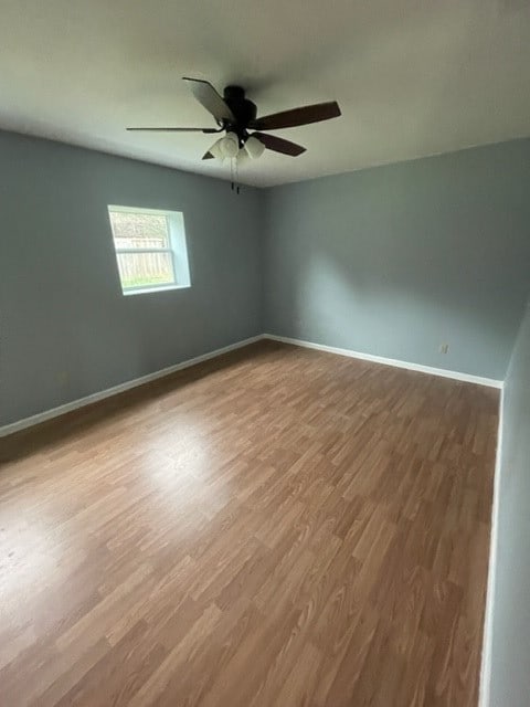 spare room with ceiling fan and hardwood / wood-style flooring