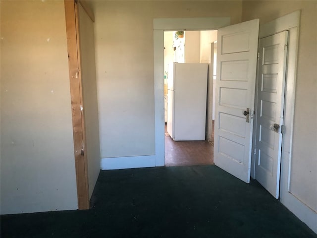 hall with dark wood-type flooring