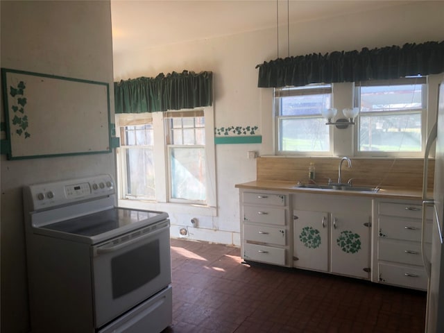 kitchen featuring pendant lighting, sink, white electric range oven, white cabinets, and backsplash