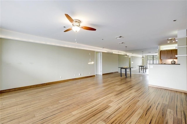 unfurnished living room featuring light hardwood / wood-style flooring and ceiling fan