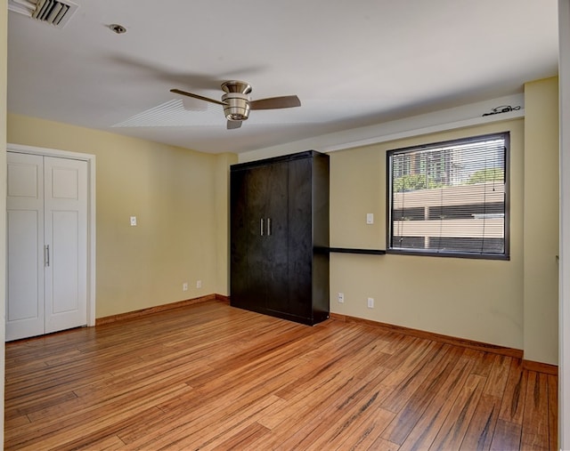 unfurnished bedroom featuring hardwood / wood-style flooring and ceiling fan