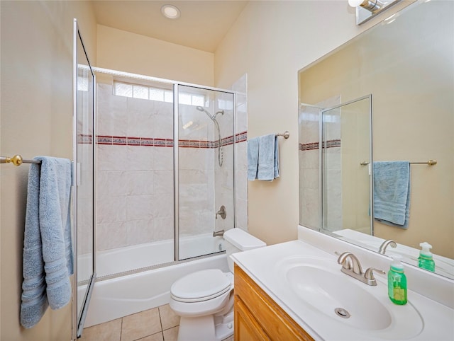 full bathroom with shower / bath combination with glass door, toilet, vanity with extensive cabinet space, and tile flooring